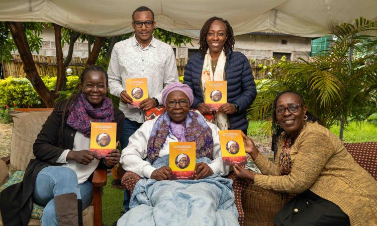 WEE Hub team pose with Prof Eddah Gachukia displaying the book