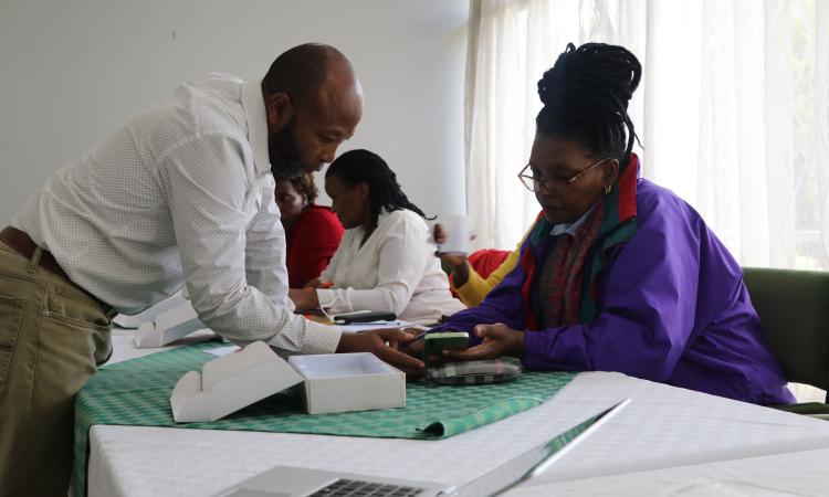 Trainer guides Reseach Assistant during training session